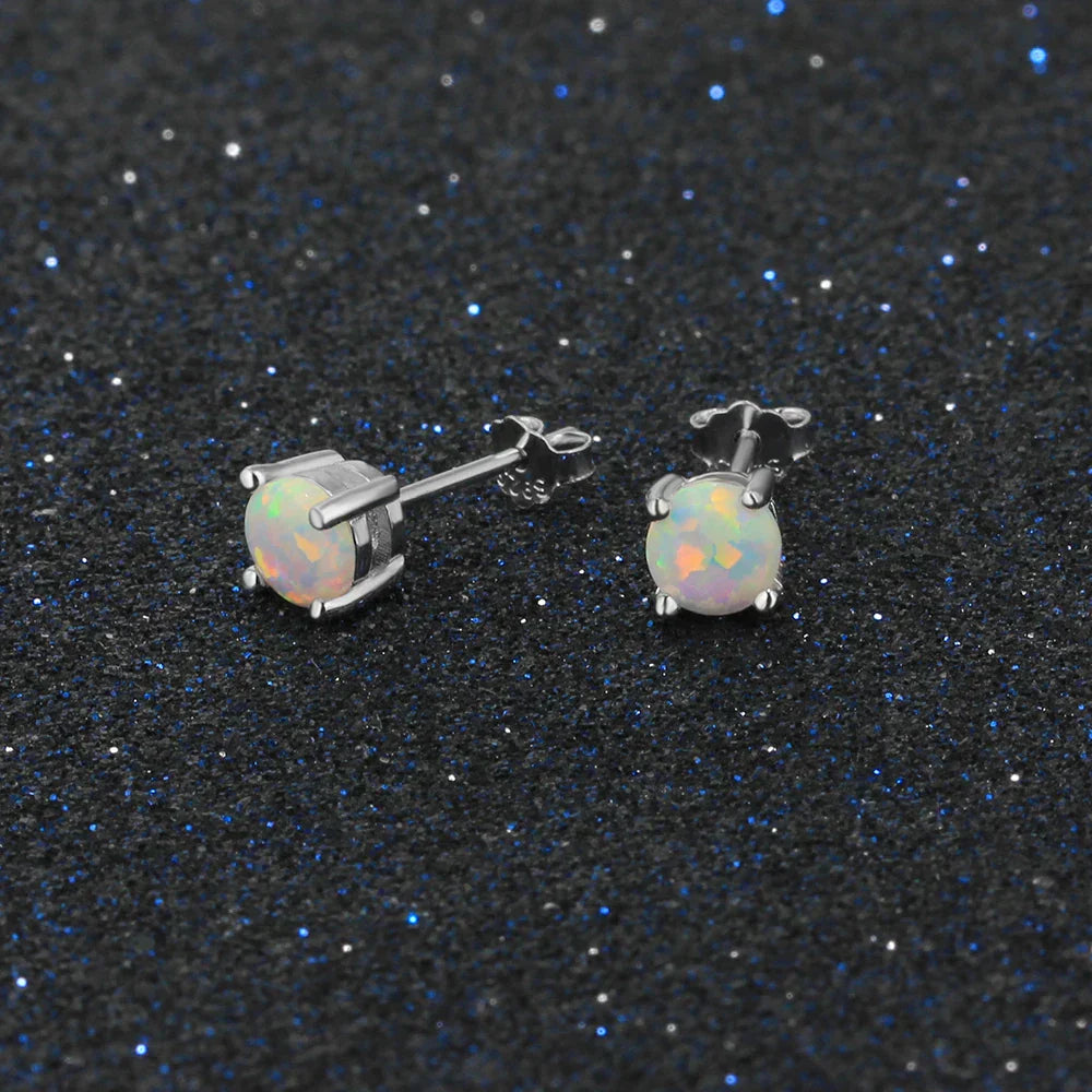 Close-up of round white opal stud earring in polished 925 sterling silver setting 