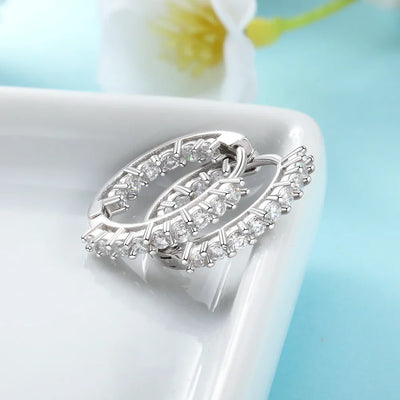 925 Sterling Silver Cubic Zirconia Hoop Earrings Women laid flat to show craftsmanship. 