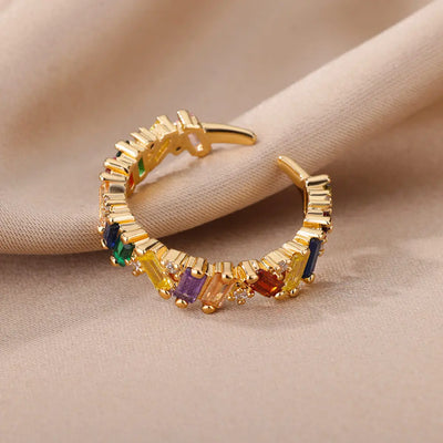 Zircon Crystal Stone Rainbow Rings Wedding Jewelry flat-lay on  surface for product showcase.