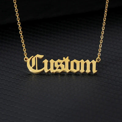 Old English custom name necklace in gold stainless steel with link chain.