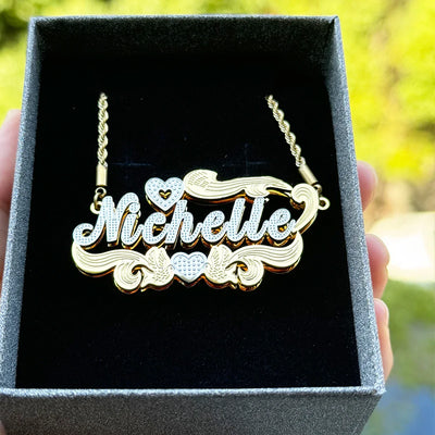 Custom Name Necklace 3D Stainless Steel close-up of engraved cursive name on polished steel pendant. 