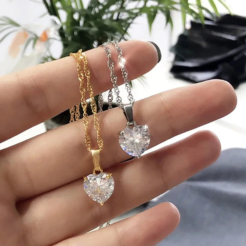 Gold and silver stainless steel heart pendant necklaces with CZ crystals.