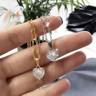 Gold and silver stainless steel heart pendant necklaces with CZ crystals.